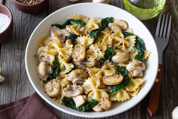 Farfalle pasta with mushrooms and spinach. Healthy eating. Vegetarian food.
