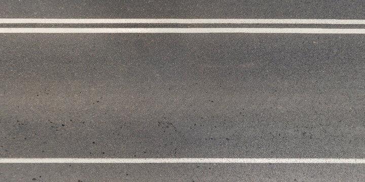 view from above on texture of asphalt road with cracks