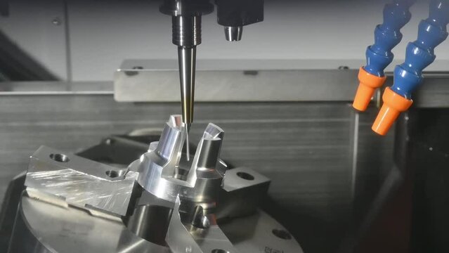 Slow motion scene the 5-axis CNC milling machine  cutting the automotive part with solid ball end mill tool.