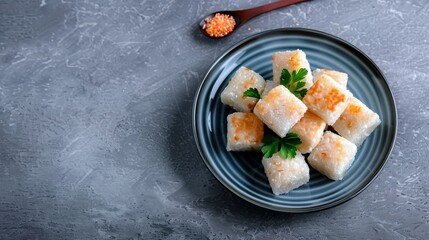 Plate of delicious rice cakes garnished with parsley on a rustic gray background. Perfect for healthy snacks and vegetarian dishes.