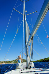 Obraz premium Summer Sailing Croatia. Man is standing at the edge of the boat