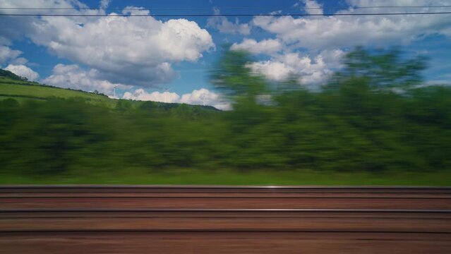 View from the window of high speed train. Beautiful trip with countryside scenery, clouds. A view of France landscape from the window of high speed train