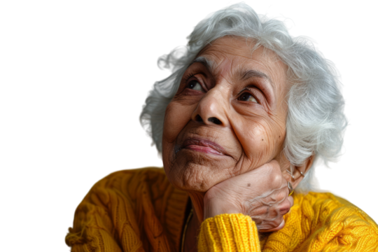Elderly Indian woman looking up, thinking, and feeling hopeful with an idea.