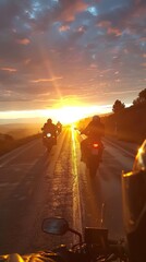 The image captures two adventurous motorcyclists with their bikes, ready to start a new journey as the rising sun offers a warm glow over the horizon, promising an exciting adventure ahead.