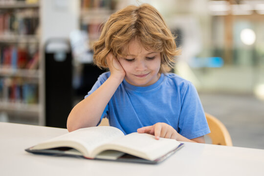 Kid reading book. Child reading book in school library. Learning from books. School education. Back to school Child reading book in a public library.
