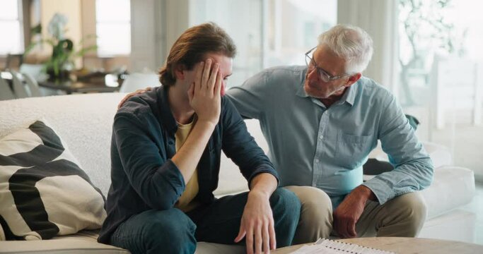 Empathy, pain or support with father and son on sofa in living room of home together for bonding. Grief, loss or love with old man talking to teenager in apartment for advice, help or trust as family
