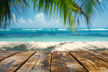 polished wooden table or platform with a smooth horizontal texture in the lower foreground, with a blurred tropical beach scene, including palm tree fronds on the upper left and right 