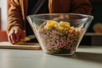 Man cutting potatoes for salad at kitchen