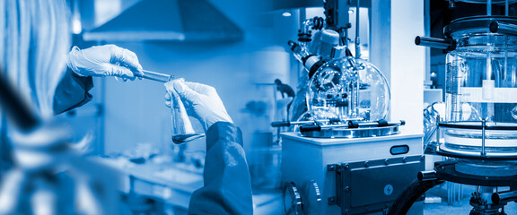 Scientific biological laboratory. Hands of laboratory assistant with test tubes. Equipment for...