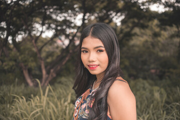 Young woman in boho fashion outdoors with serene background