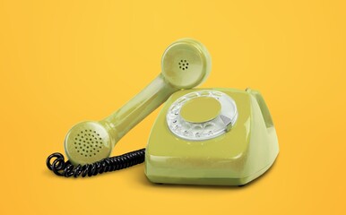 Vintage retro phone on color background
