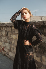 Elegant woman wearing black lace maxi dress