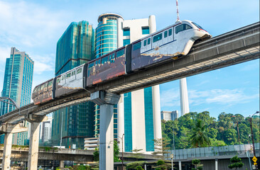 An LRT train,runs along the efficient overhead railway system,high above KL city center,avoiding busy roads below,Kuala Lumpur,Malaysia.