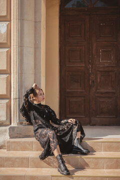 Fototapeta Elegant woman wearing black lace maxi dress