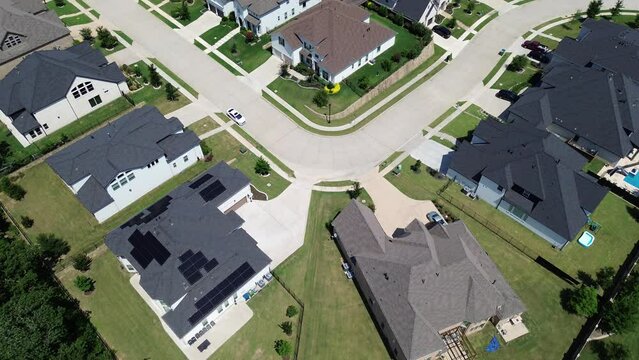Upscale suburban neighborhood new development two story houses solar roof panels, sustainable modern Texas homes in Dallas Fort Worth suburbs, Flower Mound expensive residential area, flyover
