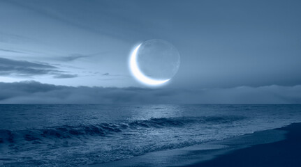 Ramadan concept - Crescent moon over the tropical sea at night 