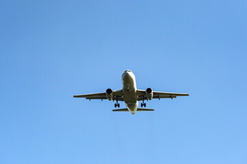Unmarked holiday jet isolated against a blue sky. Travel concept. Copy space.