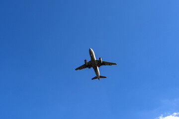 Unmarked holiday jet isolated against a blue sky. Travel concept. Copy space.