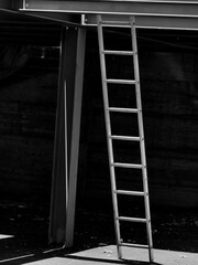 Interplay of Light and Shadow. Metal Ladders at Parking Spot Under Construction. Black and white. Monochrome.