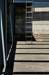 Interplay of Light and Shadow. Metal Ladders at Parking Spot Under Construction.