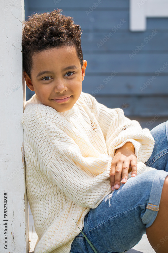 Wall mural Close up portrait of an eight year old mixed race boy, summer outdoor