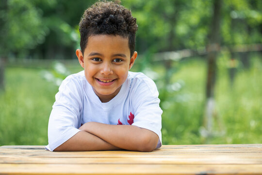 Close up portrait of an eight year old mixed race boy, summer outdoor