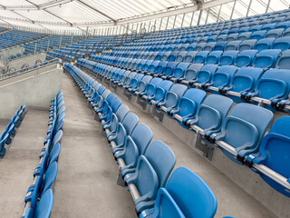 Obraz premium empty blue tribunes? seating rows in a stadium