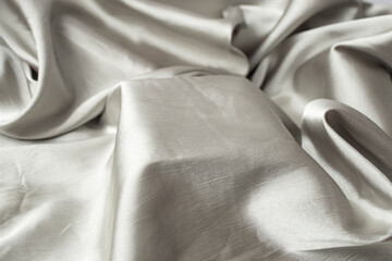 Silver silky fabric with shiny waves and a square stage in the middle for product placement, creative product display backdrop