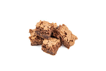 Sponge cake with chocolate filling cut in squares piled up on a white background