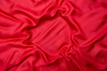 Red natural silk with ripples and waves, copy space for product placement