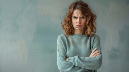 angry woman with crossed arms and furrowed brow expressing frustration portrait