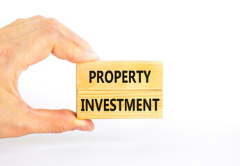 Property investment symbol. Concept words Property investment on beautiful wooden block. Beautiful white paper background. Businessman hand. Business Property investment concept. Copy space.