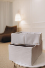 Baskets with clean clothes on shelf, closeup