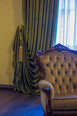 part of the curtain is draped in the interior of the room