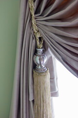 part of the curtain is draped in the interior of the room