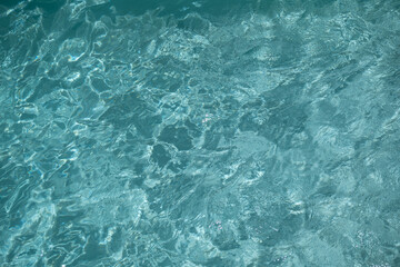 Shining turquoise water ripple background. Summer concept
