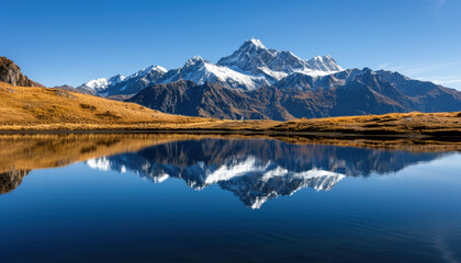 A mountain range is reflected in a lake