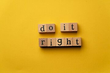 a yellow warm background without shadows wooden cubes with black letters laid out word do it right