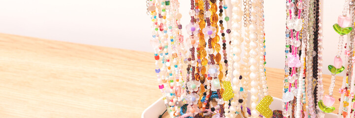 Banner with handcraft chains of beads, pearls and natural stones. Place for text.