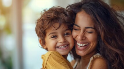 A joyful mother and her young son are embracing, sharing a moment of genuine happiness and love