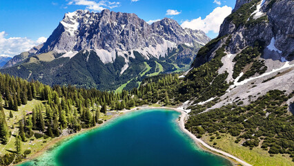 Incredibly beautiful green-blue mountain lake Seebensee in Austria, surrounded by trees and...