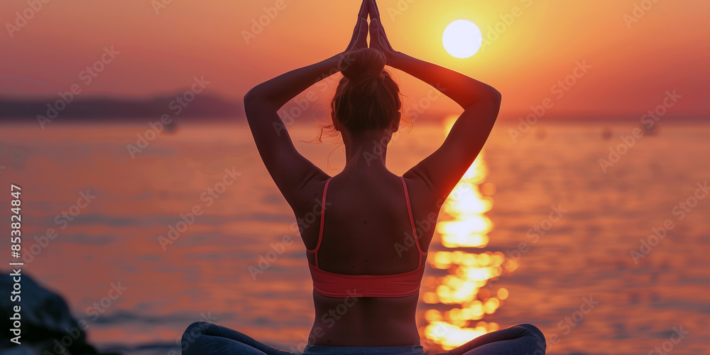 Wall mural yoga on the beach at sunset