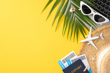 Top view of summer travel essentials including a passport, airplane, sunglasses, and palm leaves on a vibrant yellow background