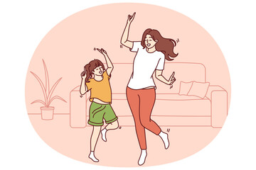 Active family of dancing young mother and daughter enjoying movement to music. Dance of teenage girl, elementary school student and mother or older sister dancing together spending free time