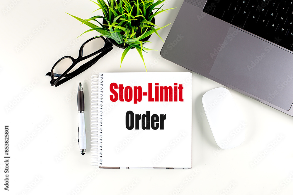 Poster stop-limit order text on notebook with laptop, mouse and pen
