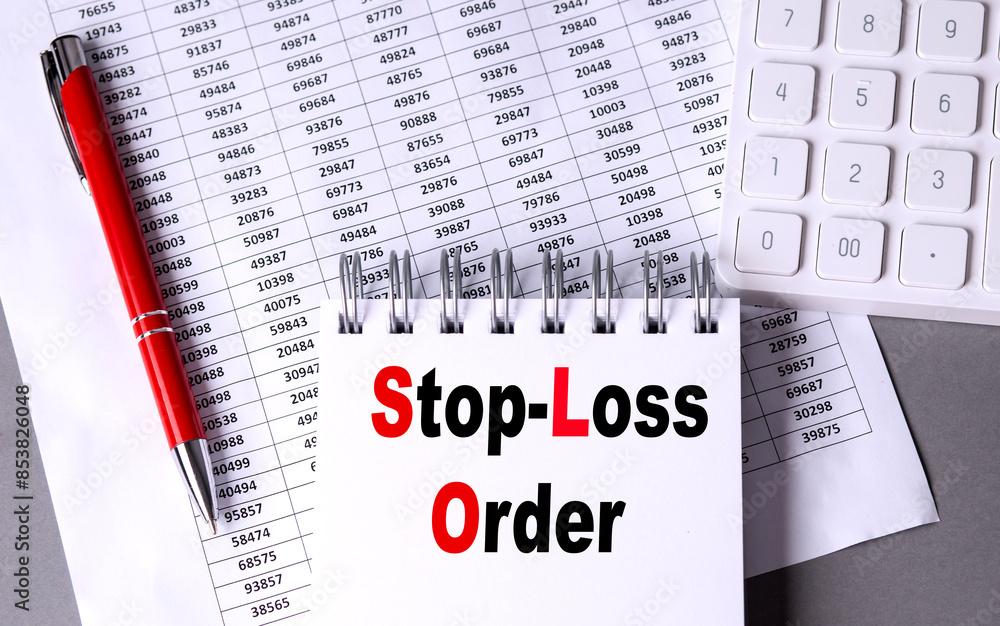 Poster stop-loss order text on notebook with chart , pen and calculator