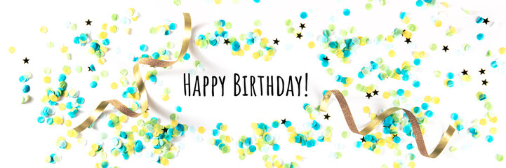 Happy birthday greeting card with confetti, golden stars and ribbons, with typography, a panorama...