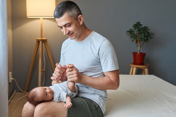 Happy childhood memories. Father and baby's love. Newborn cuddles with dad. Young father holding...
