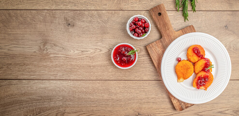 Deep fried camembert nuggets. Baked or fried Camembert or brie cheese with cranberry and sauce