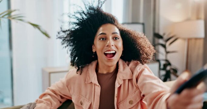 Woman, remote and watching tv with wind in living room for loud volume, surprised and entertainment on sofa in home. Person, wow and amazed with fantasy movie, television series and fun advertisement